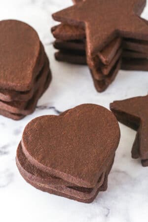 stacks of chocolate cutout cookies on marble counter