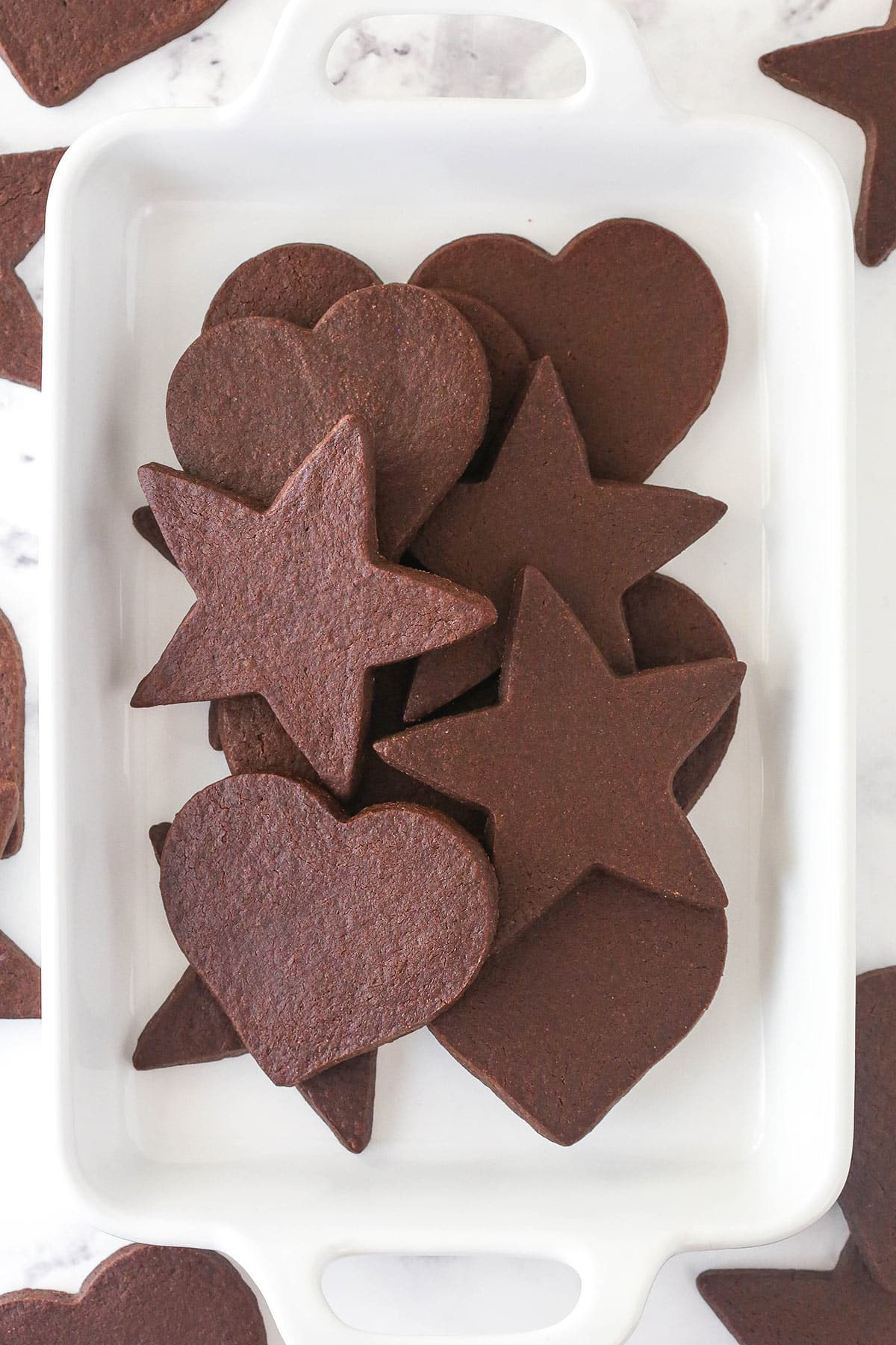 Overhead view of a tray of cutout chocolate cookies