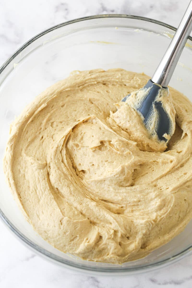 Stirring gelatin powder into peanut butter in a bowl