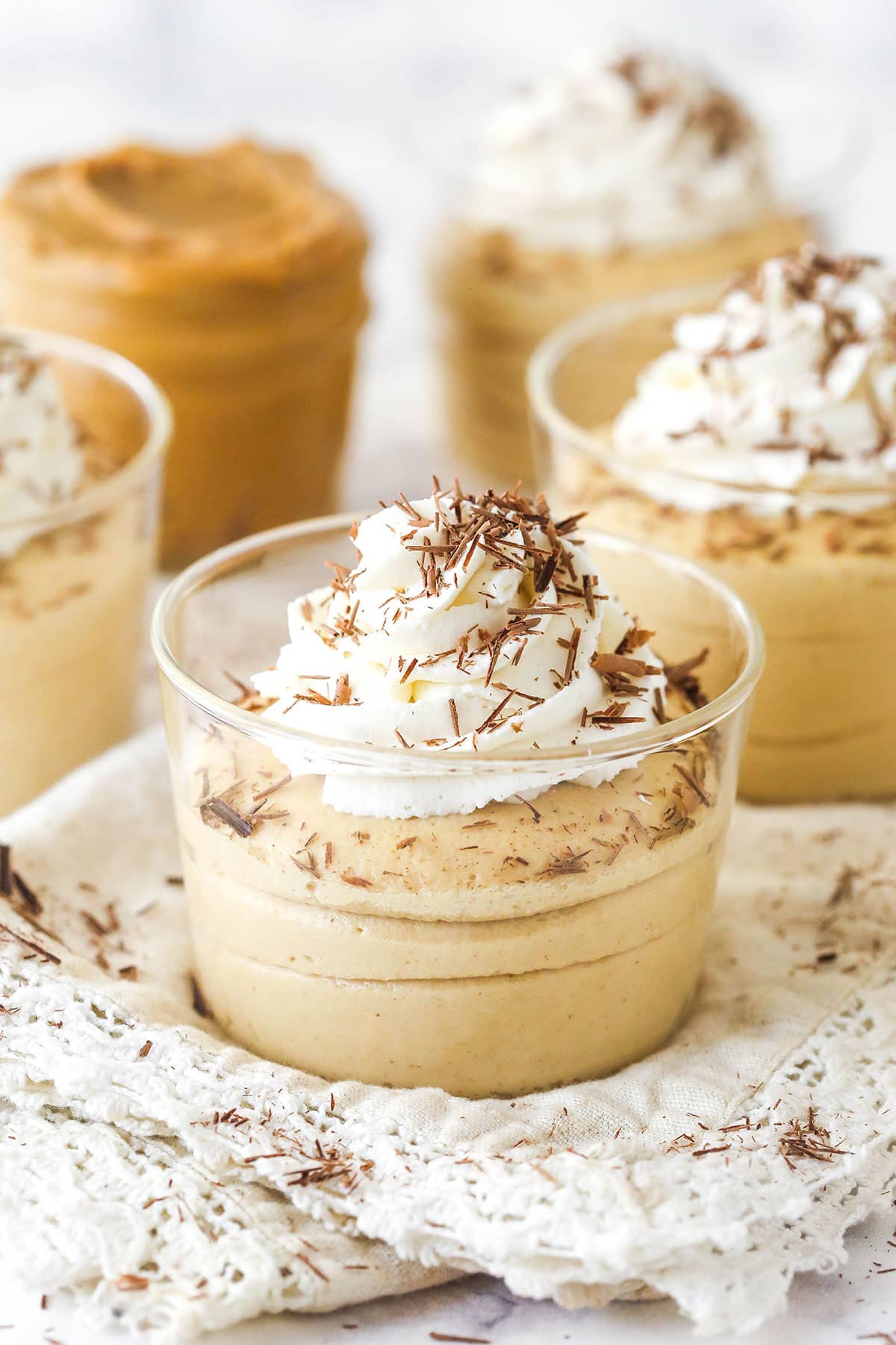 Peanut butter mousse topped with whipped cream in glasses