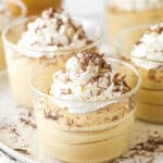 Glasses of peanut butter mousse topped with whipped cream