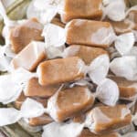 homemade caramels wrapped in wax paper in grey dish