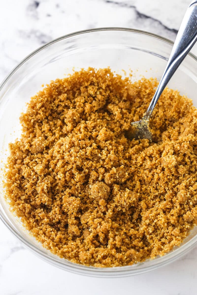 Graham cracker crumbs and butter in a bowl