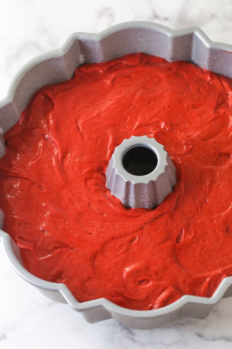 Red velvet cake batter in a bundt pan