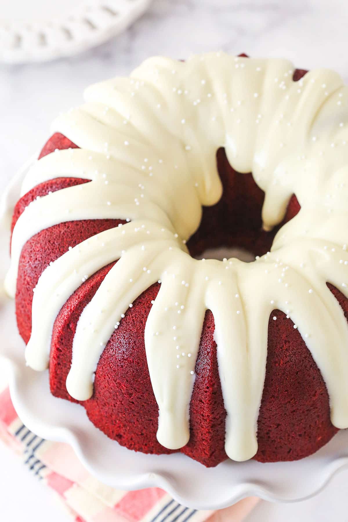 Overhead view of a red velvet bundt cake with cream cheese icing