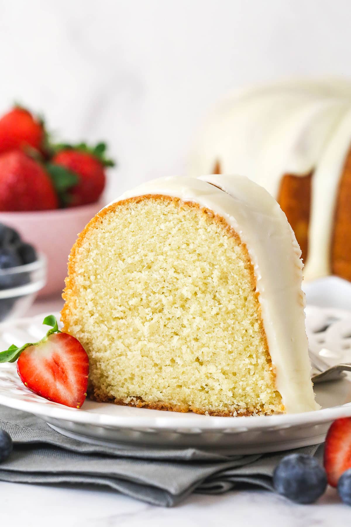 A slice of vanilla bundt cake on a white plate