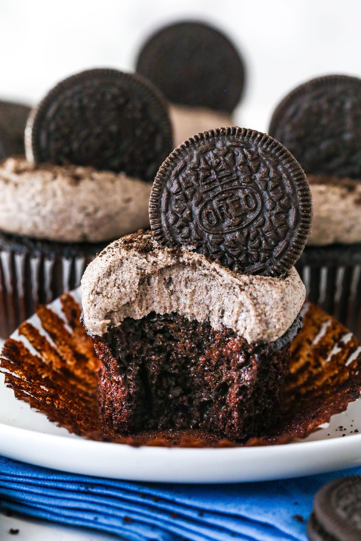 An Oreo cupcake with a bite taken out of it.