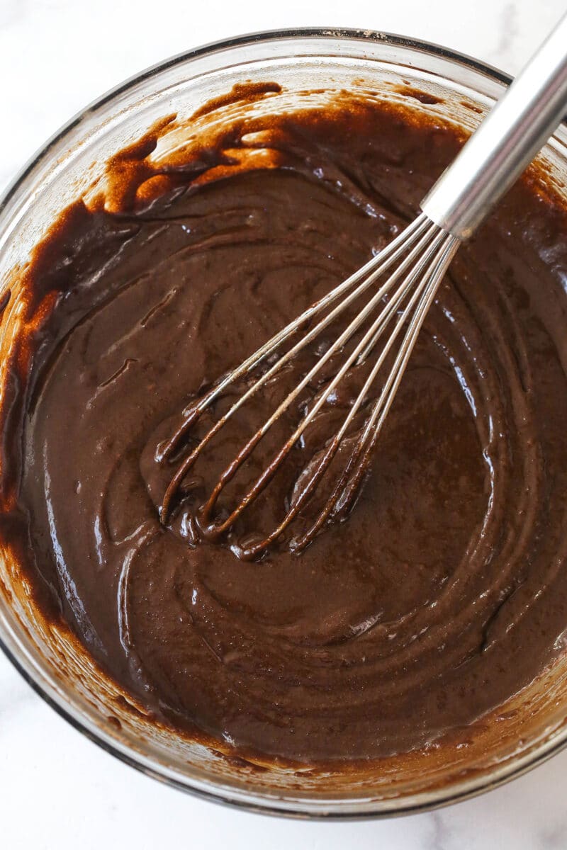 Adding dry ingredients to wet ingredients for brownie batter.