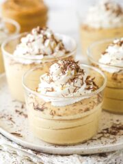 Glasses of peanut butter mousse topped with whipped cream