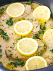 Cooked Chicken Breasts in a Slow Cooker with Sauce, Herbs and Lemon Slices