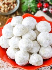 Overhead view of Russian Tea Cakes stacked in a red platter